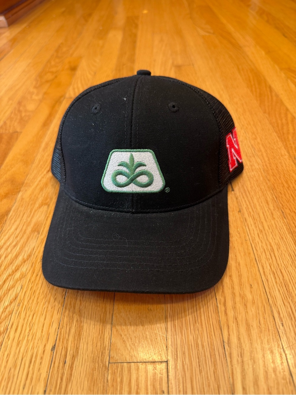 Coreva X Nebraska Black Trucker Hat with Green Logo - Branded Cap